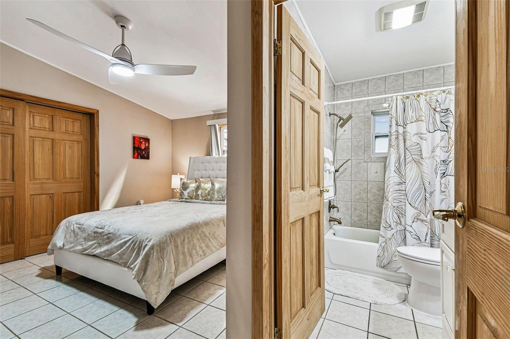 226 Maple Avenue Palm Harbor, FL 34684 - Photo 29 of 79 a bedroom with a bed and a shower