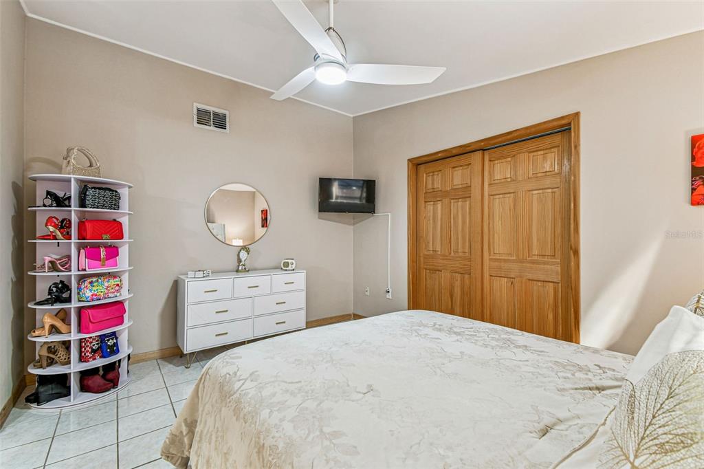 226 Maple Avenue Palm Harbor, FL 34684 - Photo 30 of 79 a bedroom with a bed and cabinets