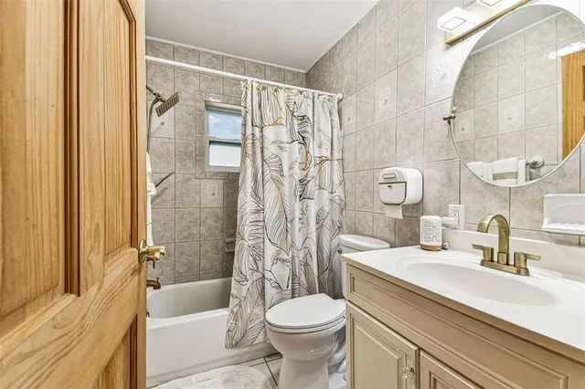 a view of a house with a yard and tree