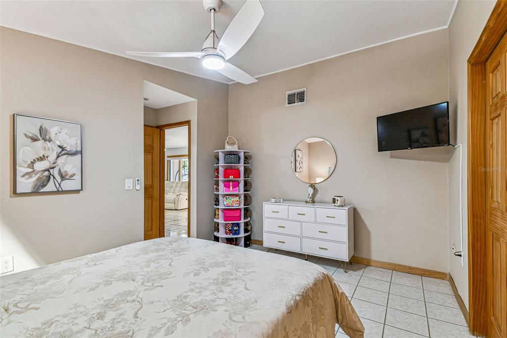 226 Maple Avenue Palm Harbor, FL 34684 - Photo 36 of 79 a bedroom with a bed and a flat screen tv