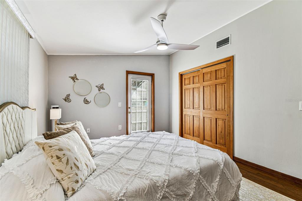 226 Maple Avenue Palm Harbor, FL 34684 - Photo 38 of 79 a bedroom with a large bed and a chandelier