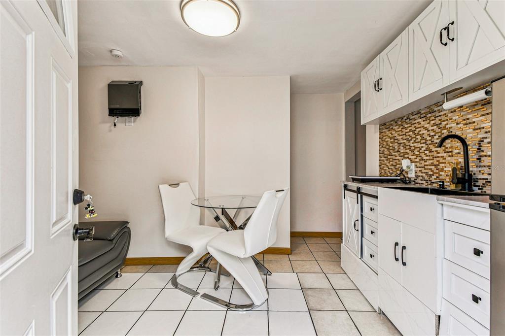 226 Maple Avenue Palm Harbor, FL 34684 - Photo 47 of 79 a dining room with furniture and a window