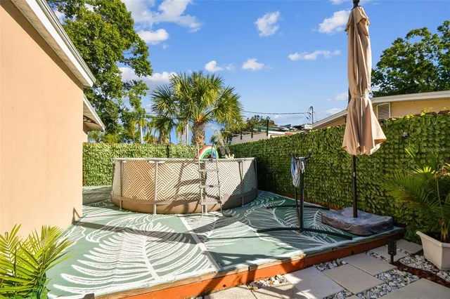 an aerial view of residential houses with outdoor space and swimming pool