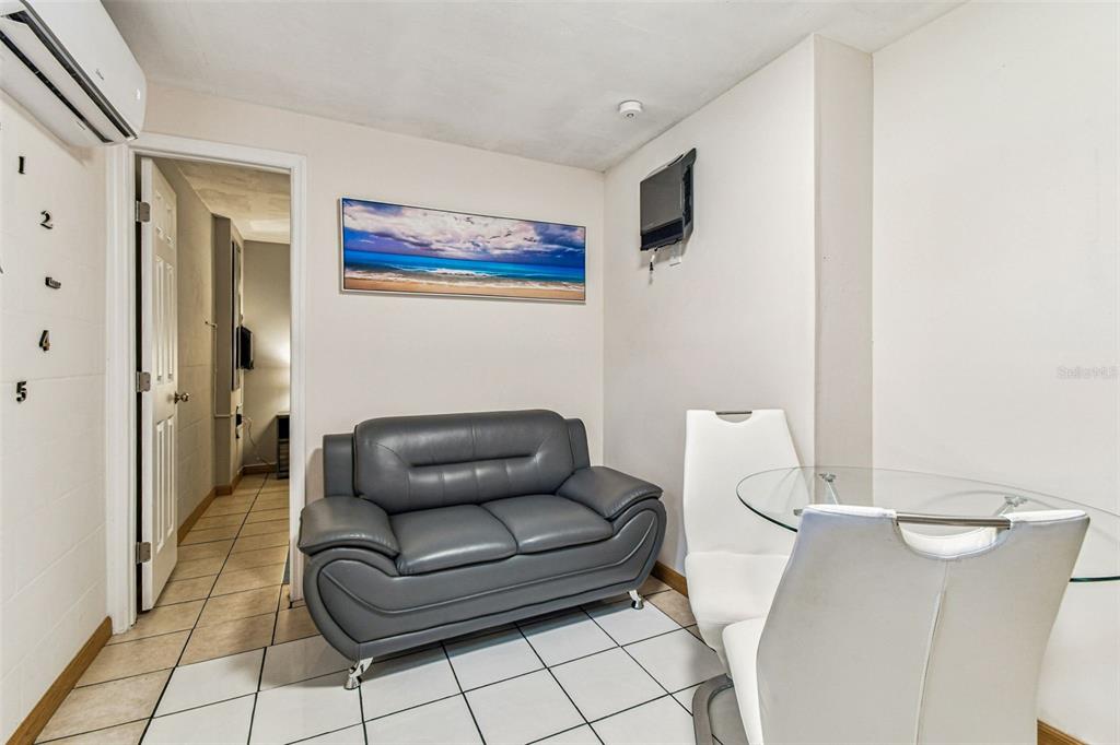 226 Maple Avenue Palm Harbor, FL 34684 - Photo 50 of 79 a living room with furniture and a air conditioner vent