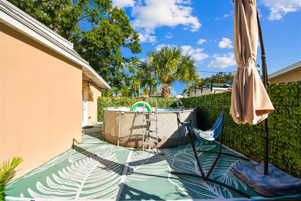 226 Maple Avenue Palm Harbor, FL 34684 - Photo 51 of 79 a view of balcony with two chairs and a potted plant