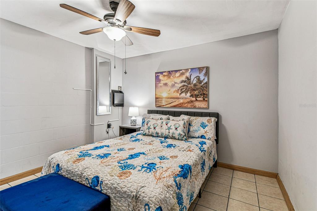 226 Maple Avenue Palm Harbor, FL 34684 - Photo 60 of 79 a bedroom with a bed and a painting on the wall