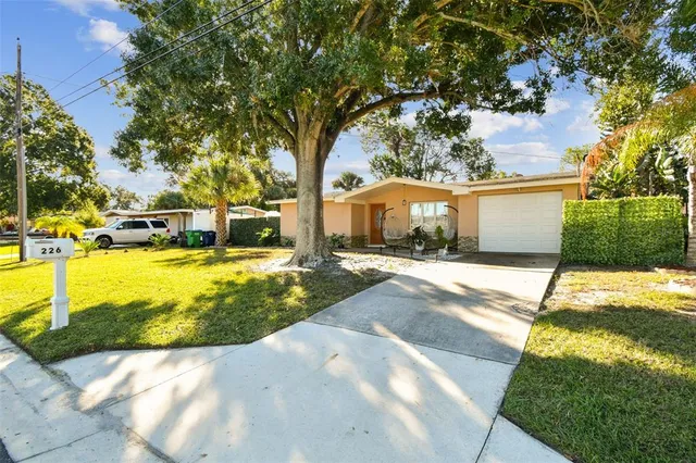 a kitchen with stainless steel appliances a refrigerator a stove a sink dishwasher and a dining table with wooden floor