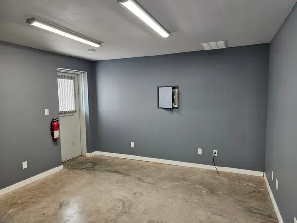 an empty room with closet and wooden floor