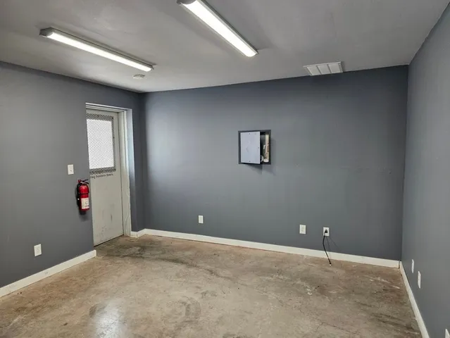 an empty room with closet and wooden floor