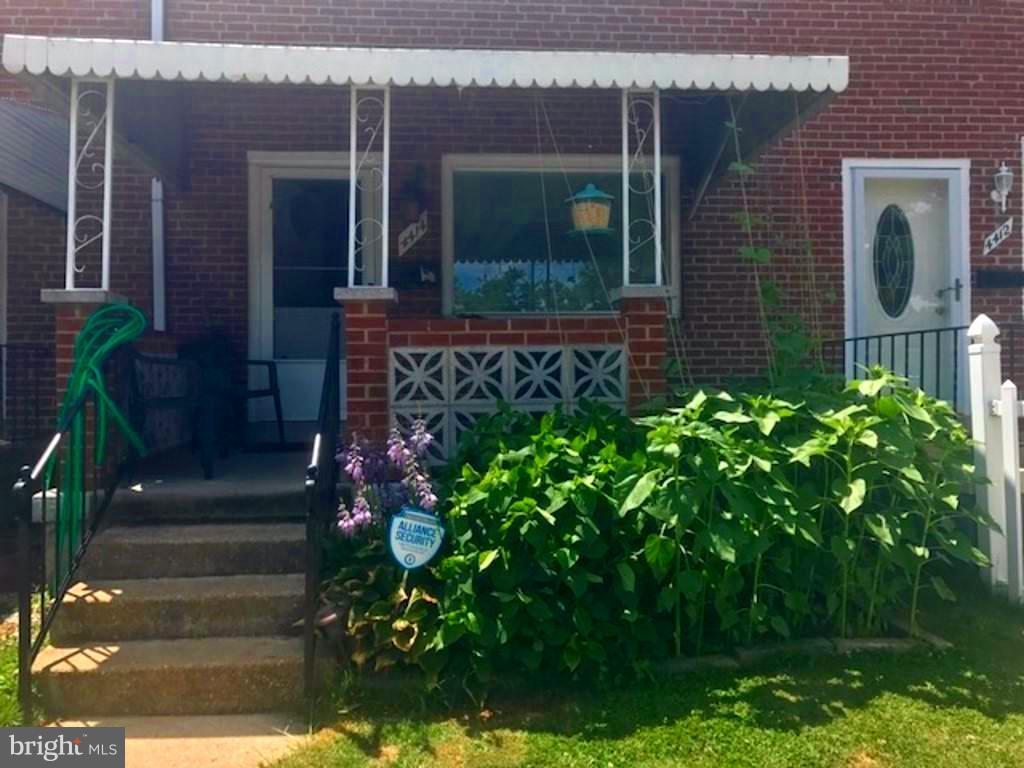 4414 Scotia Road Baltimore, MD 21227 - Photo 1 of 19 a front view of a house with garden