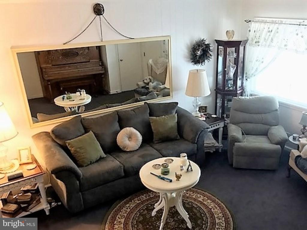 4414 Scotia Road Baltimore, MD 21227 - Photo 2 of 19 a living room with furniture and a wooden floor