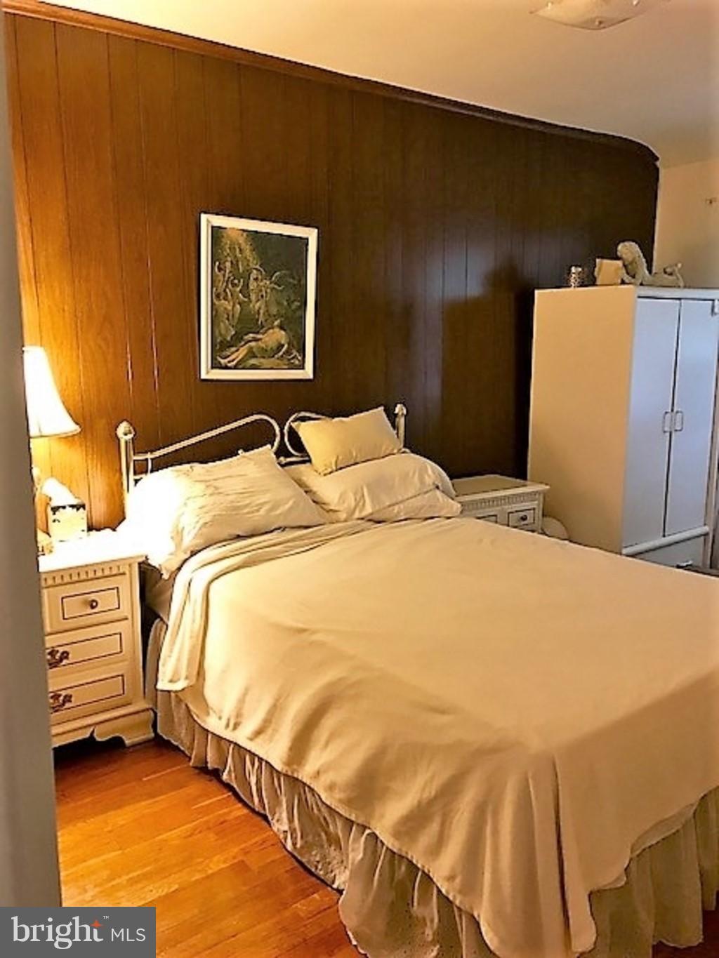 4414 Scotia Road Baltimore, MD 21227 - Photo 12 of 19 a bedroom with a bed and a painting on the wall