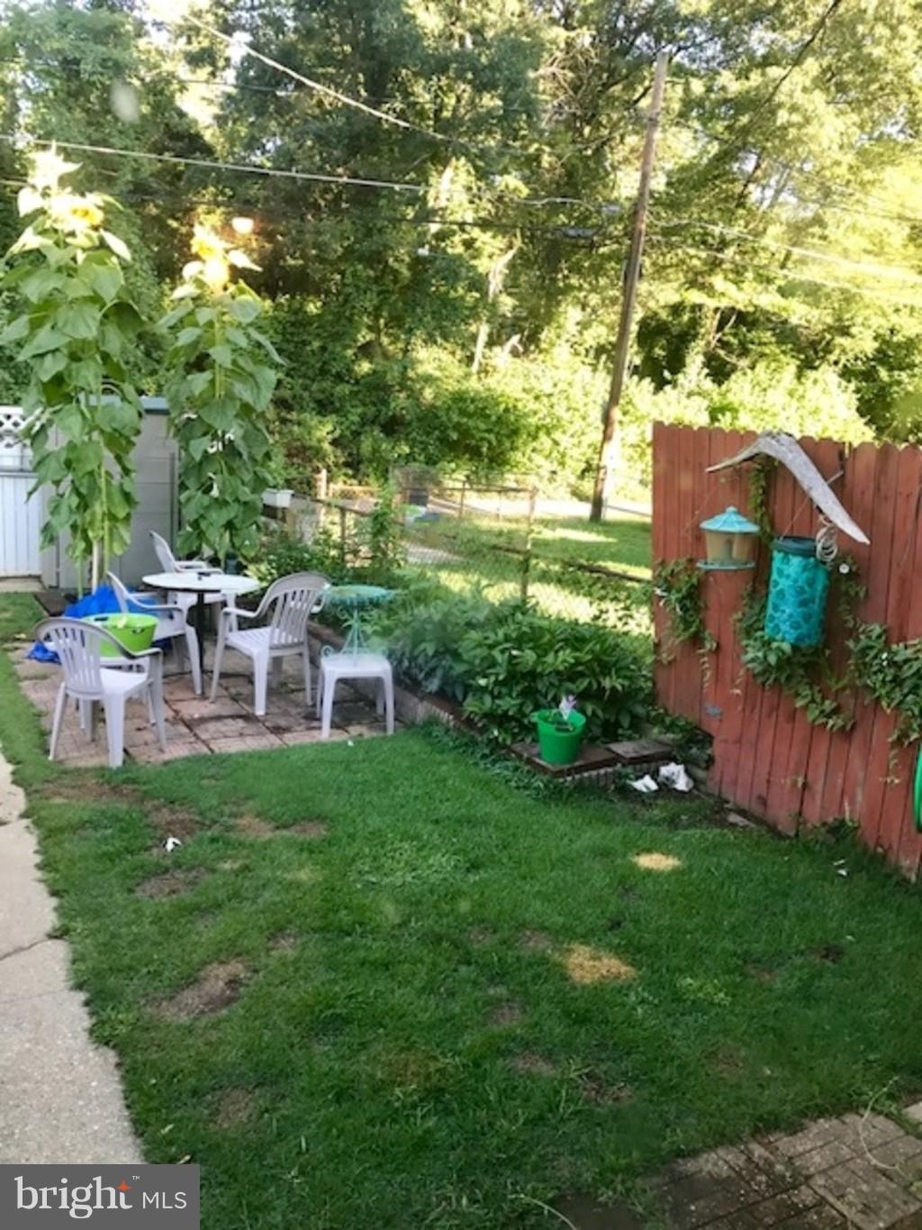4414 Scotia Road Baltimore, MD 21227 - Photo 18 of 19 a backyard of a house with table and chairs