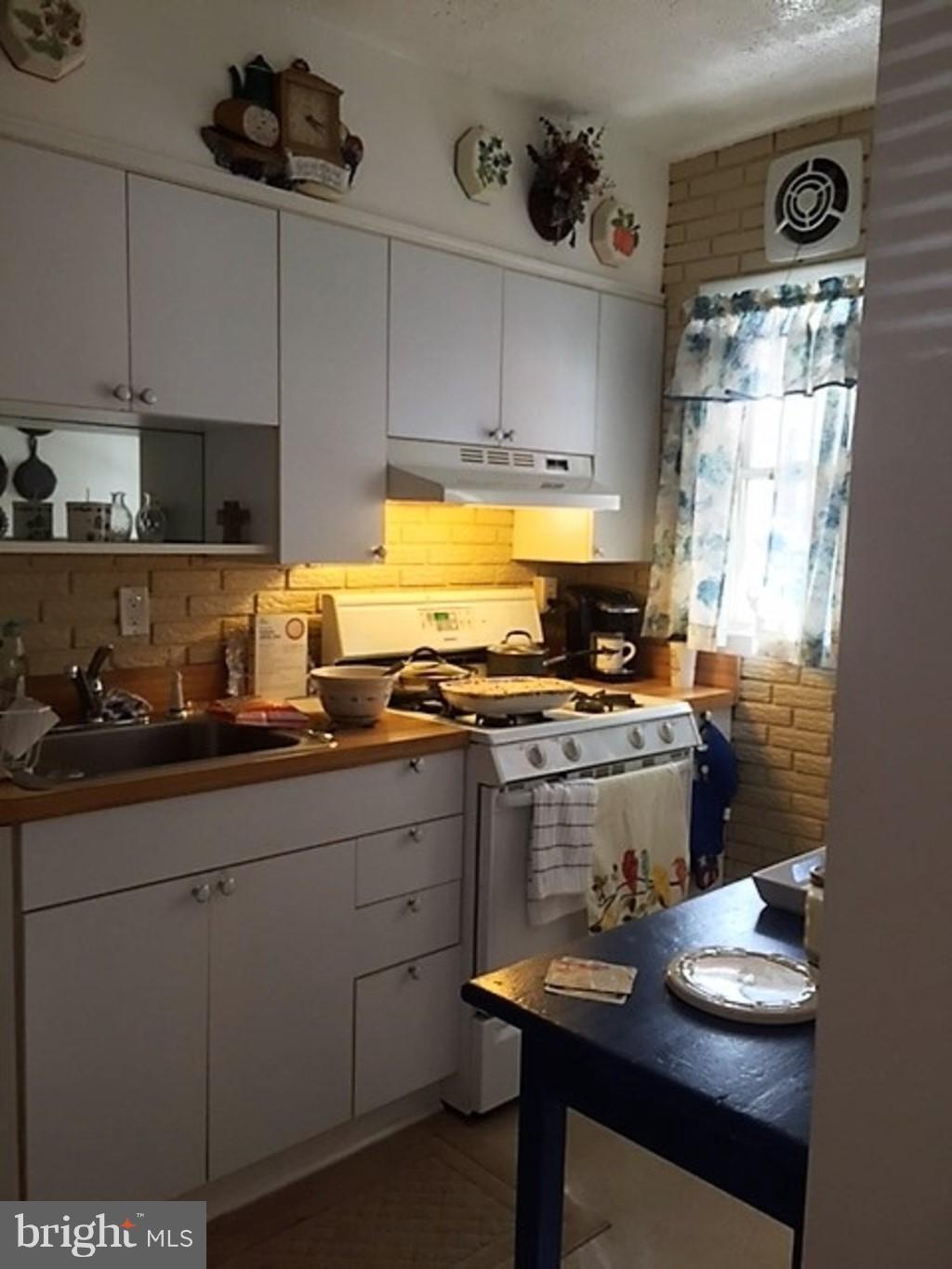 4414 Scotia Road Baltimore, MD 21227 - Photo 5 of 19 a kitchen with a sink cabinets and appliances