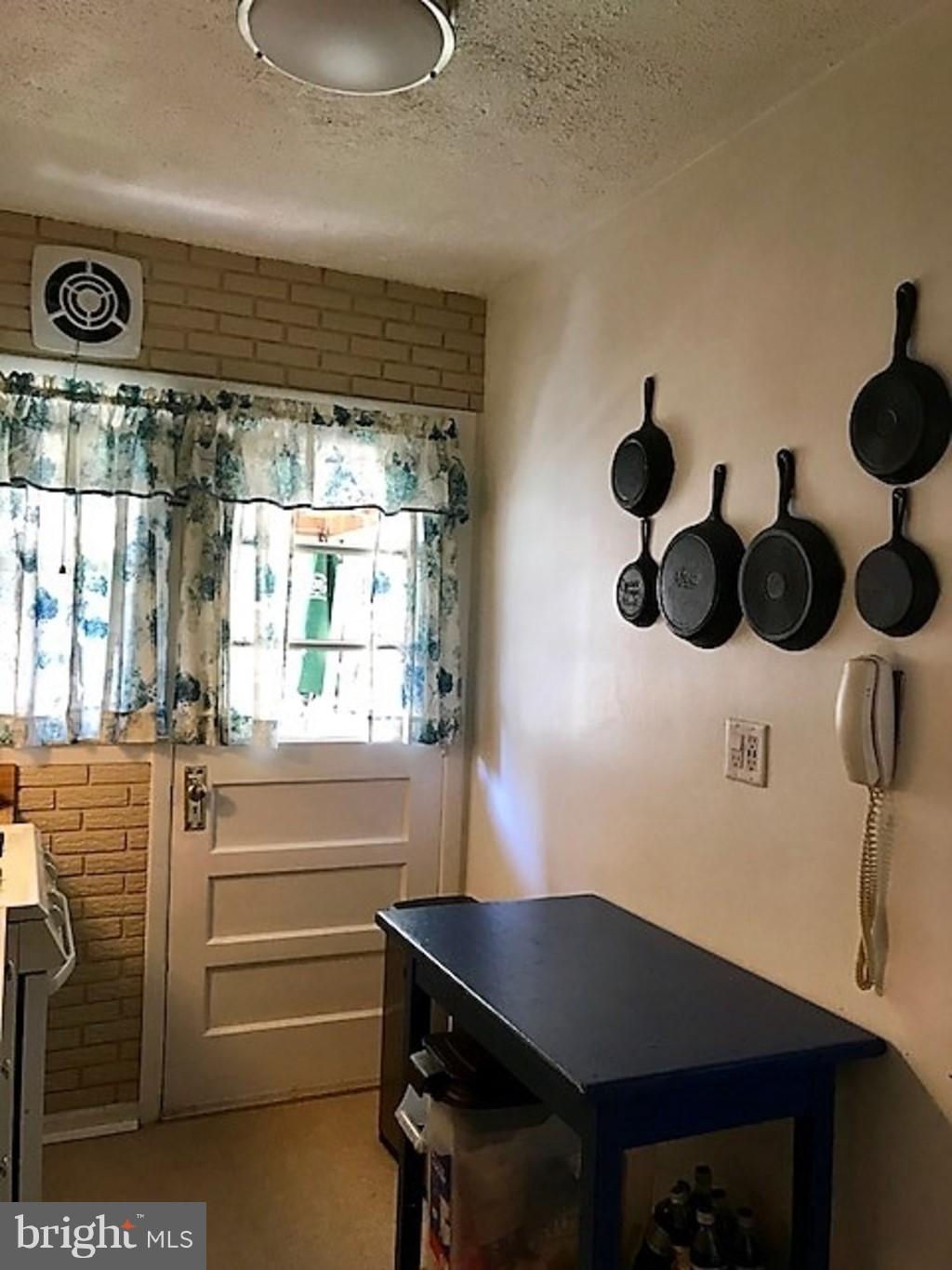 4414 Scotia Road Baltimore, MD 21227 - Photo 6 of 19 a room with a table and a window