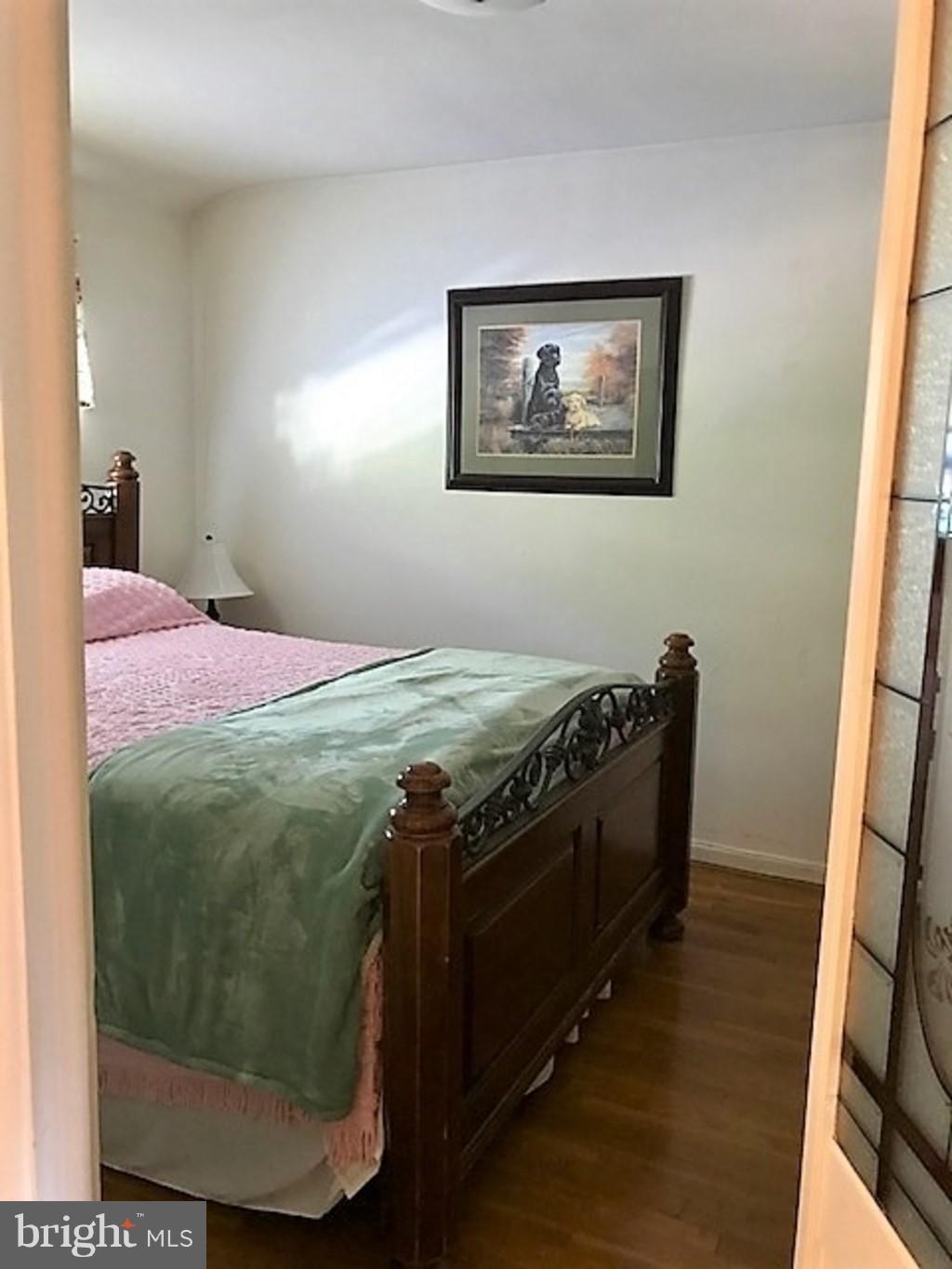 4414 Scotia Road Baltimore, MD 21227 - Photo 9 of 19 a bed sitting in a bedroom next to a window