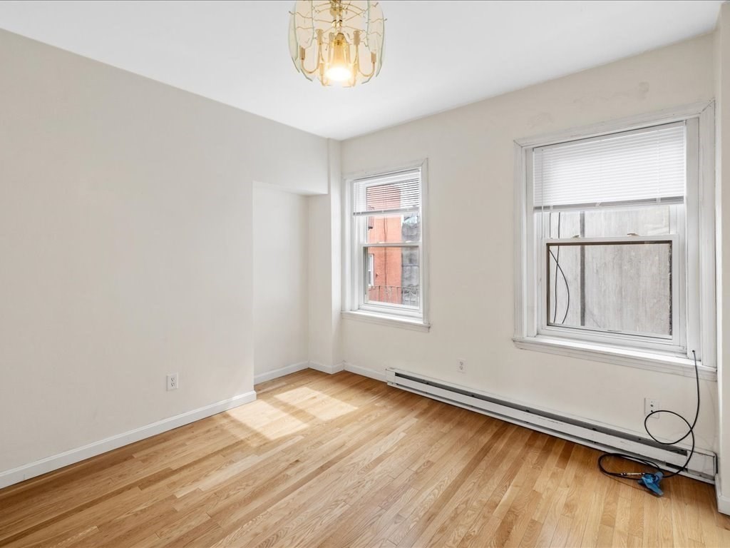 345-347 Hanover Street Boston, MA 02113 - Photo 13 of 22 an empty room with wooden floor and windows