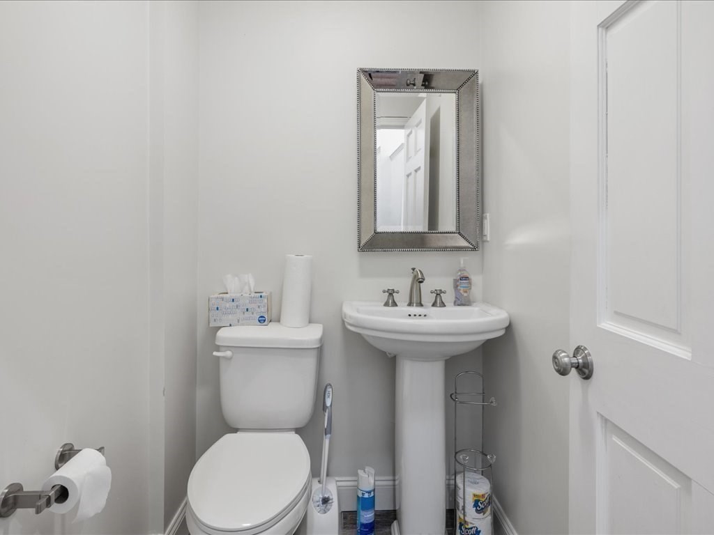 345-347 Hanover Street Boston, MA 02113 - Photo 8 of 22 a bathroom with a sink a toilet and mirror
