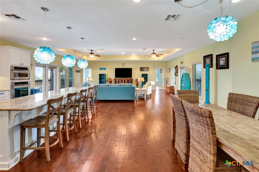 23 Macey Street Port O'Connor, TX 77982 - Photo 18 of 40 a living room with furniture and a chandelier