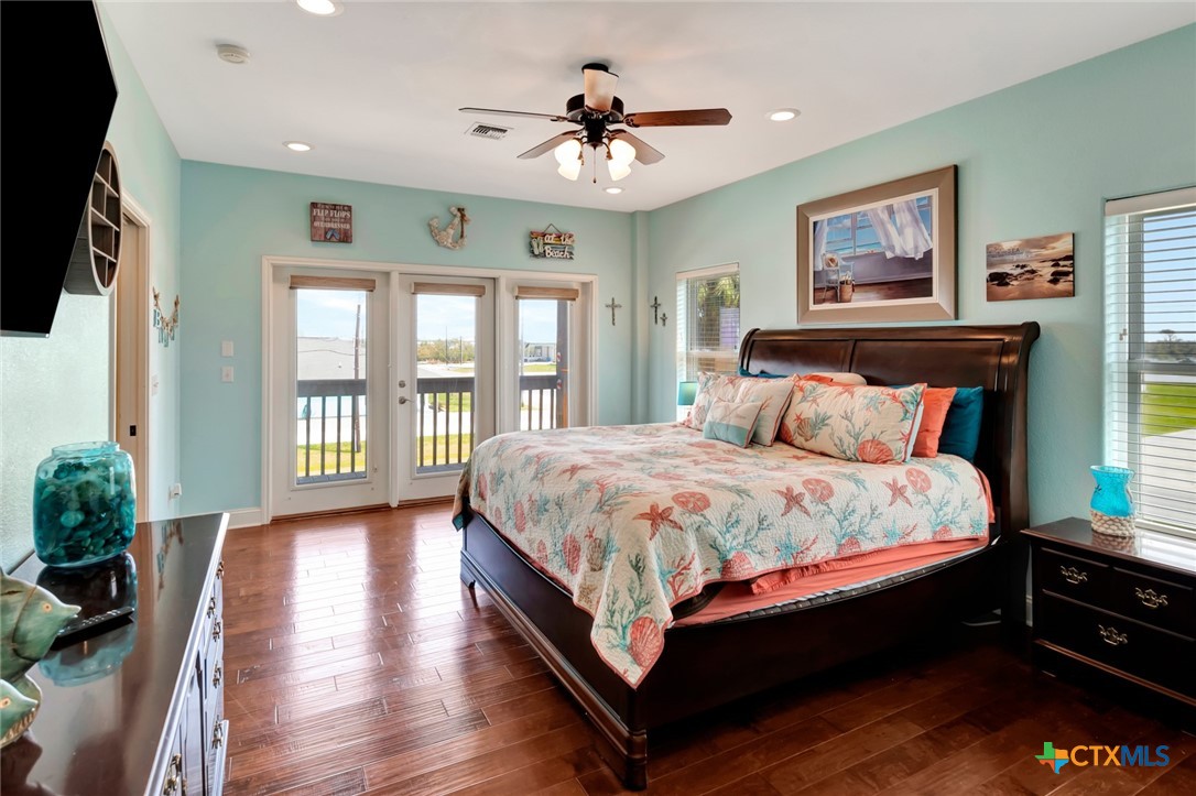 23 Macey Street Port O'Connor, TX 77982 - Photo 20 of 40 a bed sitting in a spacious bedroom next to a window
