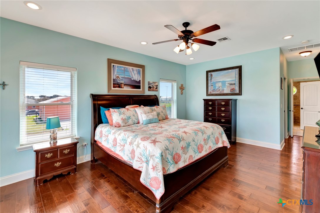 23 Macey Street Port O'Connor, TX 77982 - Photo 21 of 40 a bed sitting in a bedroom next to a window