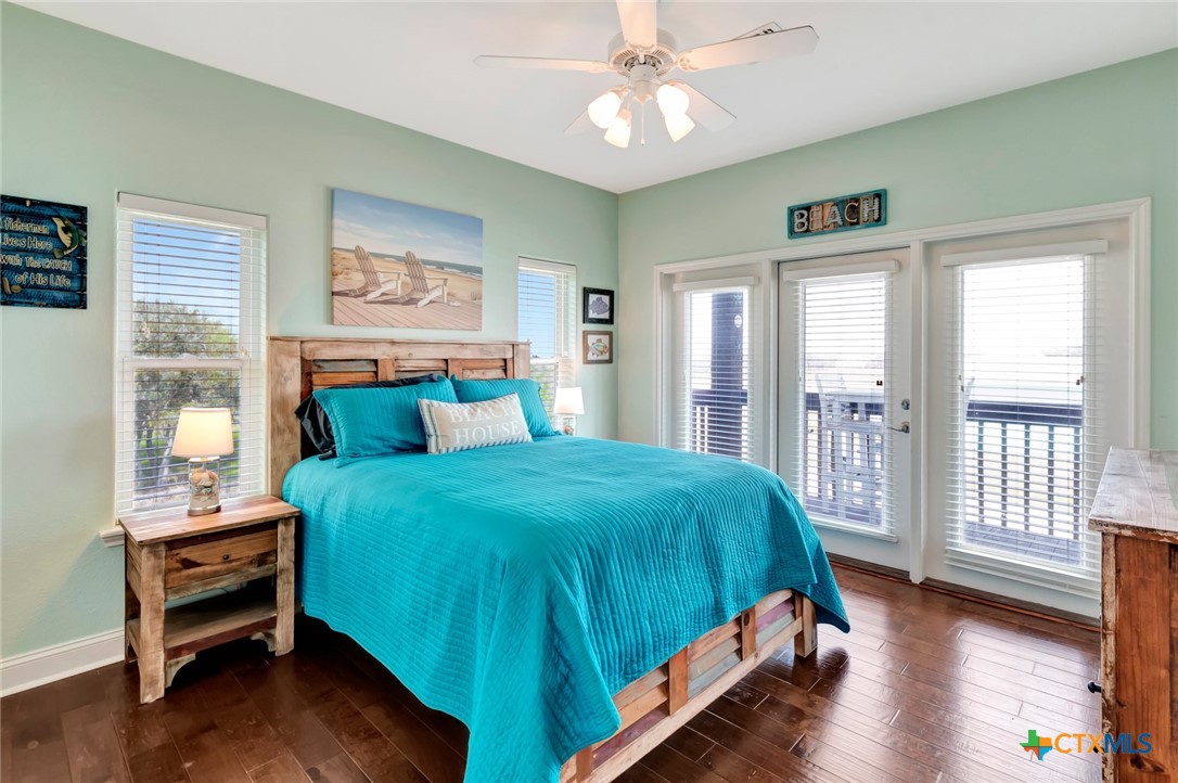 23 Macey Street Port O'Connor, TX 77982 - Photo 25 of 40 a bedroom with a bed and a large window