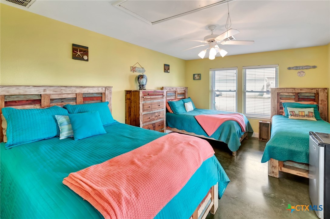 23 Macey Street Port O'Connor, TX 77982 - Photo 32 of 40 a bedroom with bed and a large window