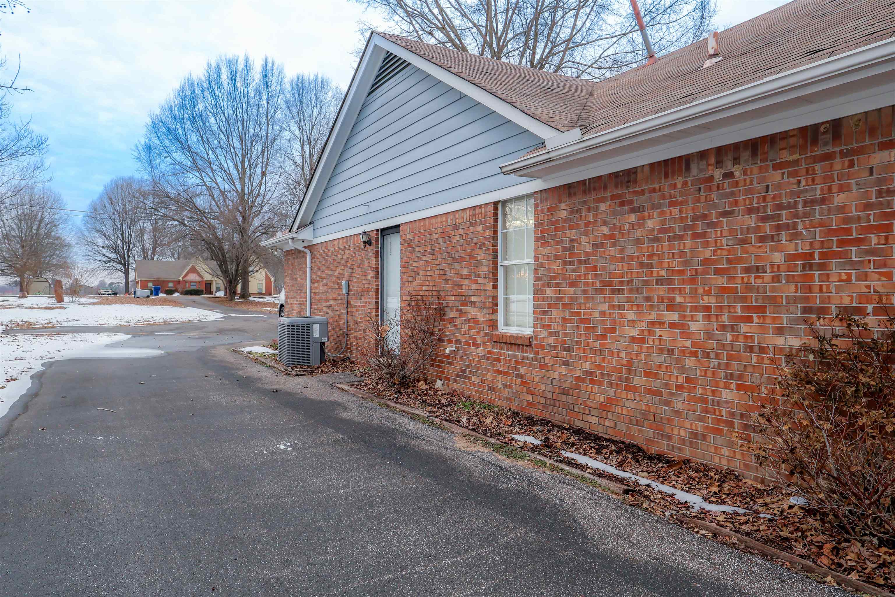 View of side of home with brick siding