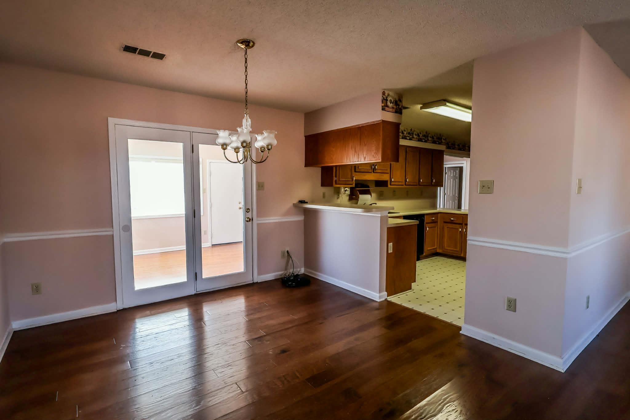 8712 Gragg Road Millington, TN 38053 - Photo 16 of 36 Kitchen with wood finish cabinets, light countertops, suspended lighting, light wood-style flooring, and a peninsula