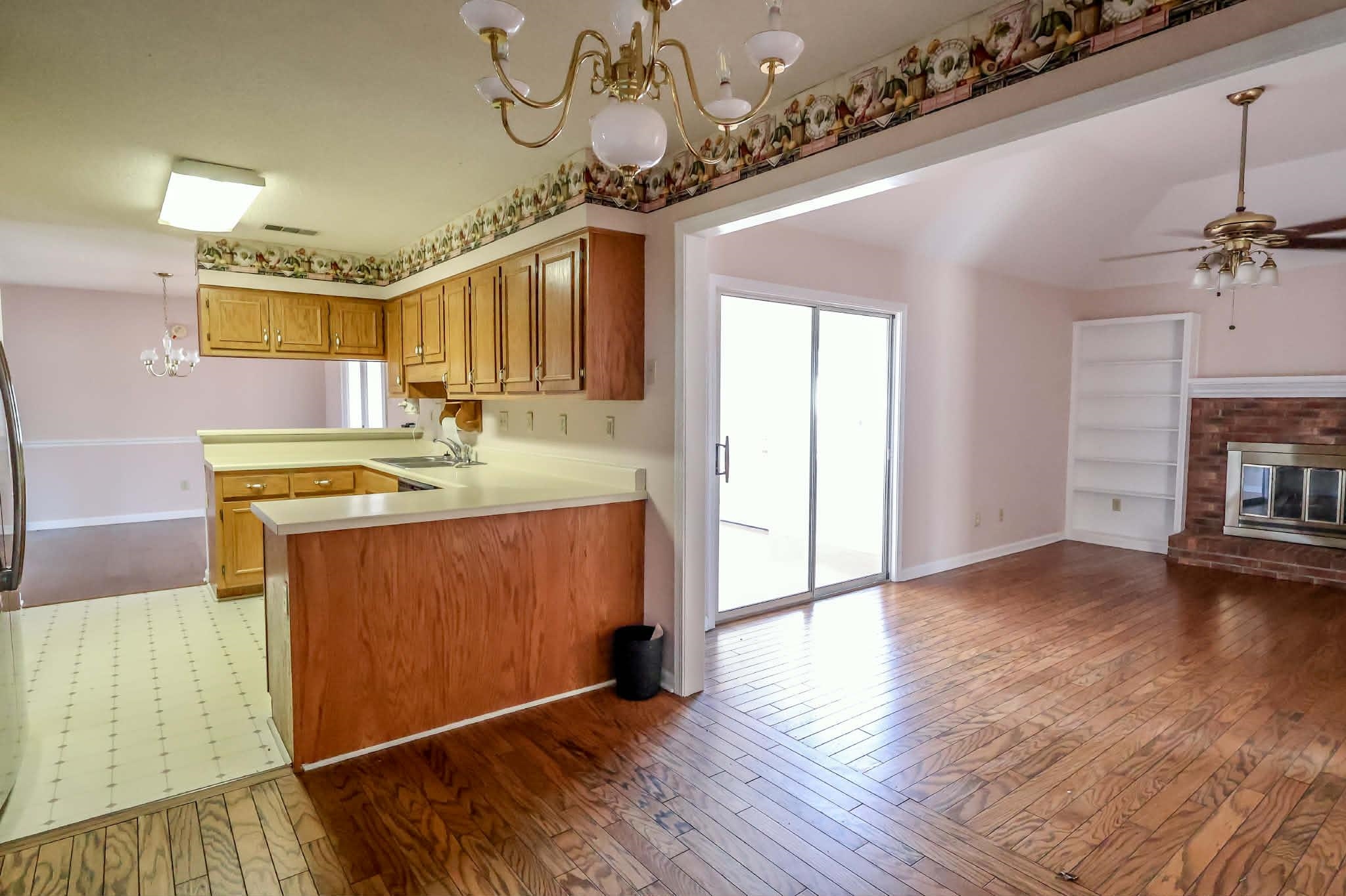 8712 Gragg Road Millington, TN 38053 - Photo 36 of 36 Kitchen featuring a chandelier, open floor plan, light countertops, wood finish cabinetry, and light wood-style floors