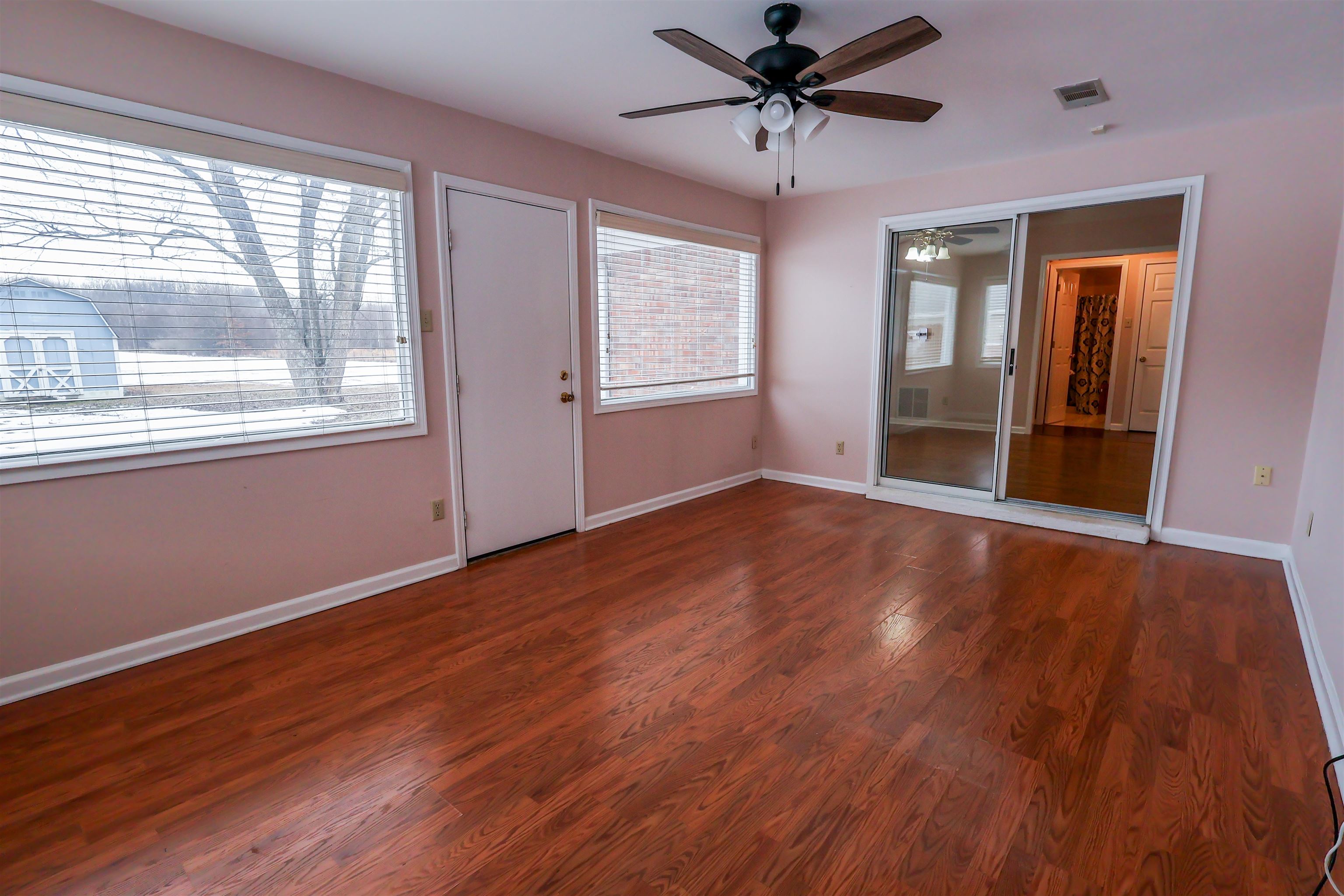 8712 Gragg Road Millington, TN 38053 - Photo 24 of 36 Unfurnished bedroom featuring wood finished floors, a ceiling fan, and a closet