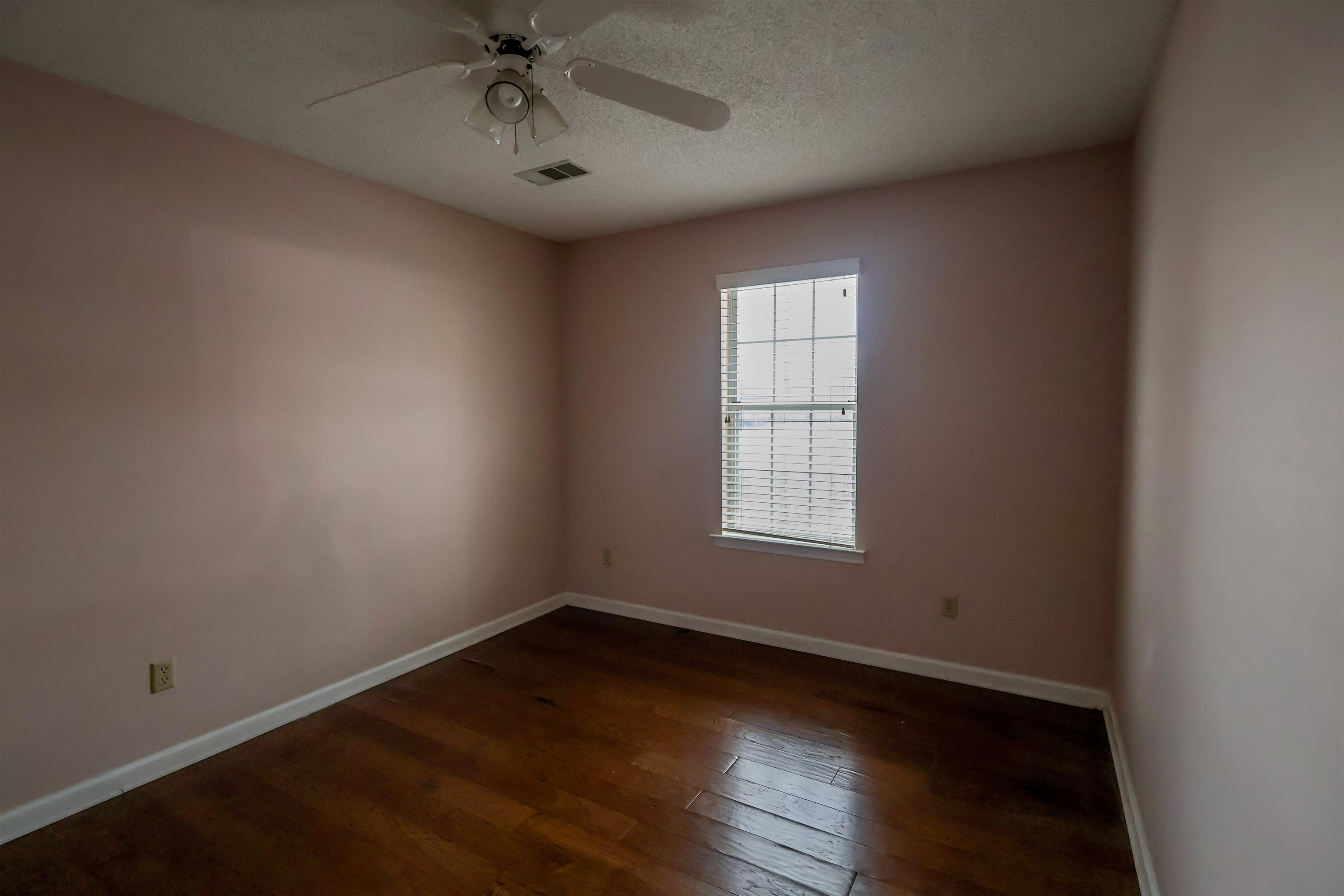 8712 Gragg Road Millington, TN 38053 - Photo 26 of 36 Spare room with dark wood-style flooring, a ceiling fan, and a textured ceiling
