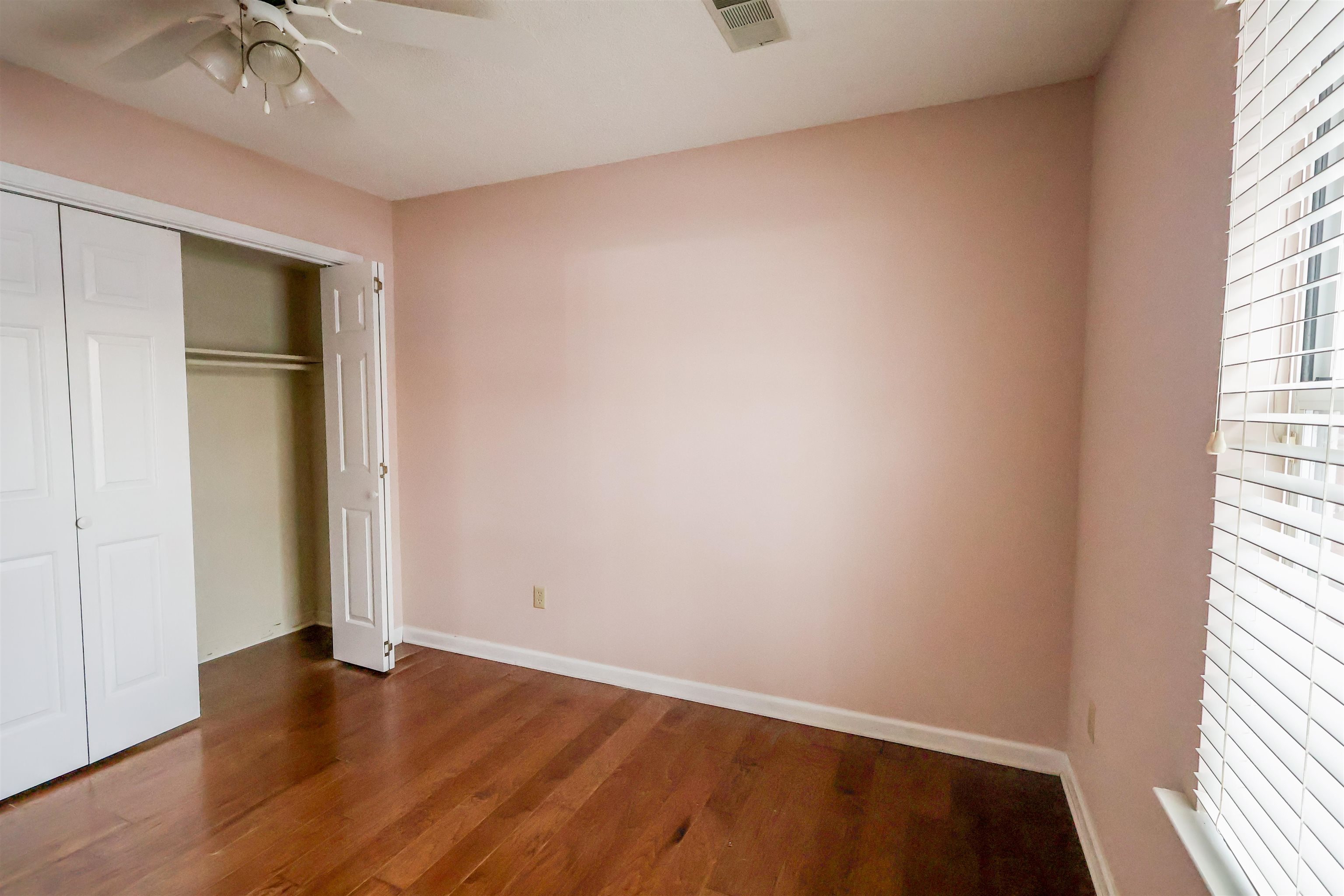 8712 Gragg Road Millington, TN 38053 - Photo 27 of 36 Unfurnished bedroom with a closet, dark wood finished floors, and ceiling fan