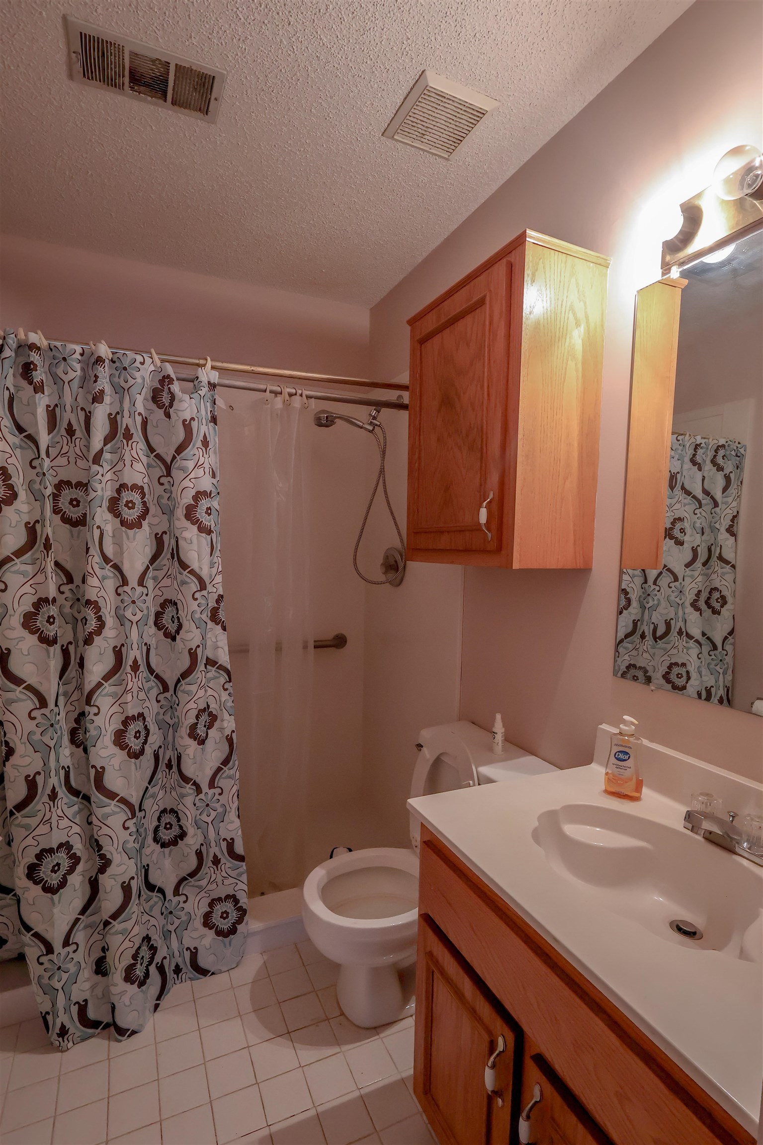 8712 Gragg Road Millington, TN 38053 - Photo 28 of 36 Full bathroom with a shower stall, a textured ceiling, vanity, and light tile patterned flooring