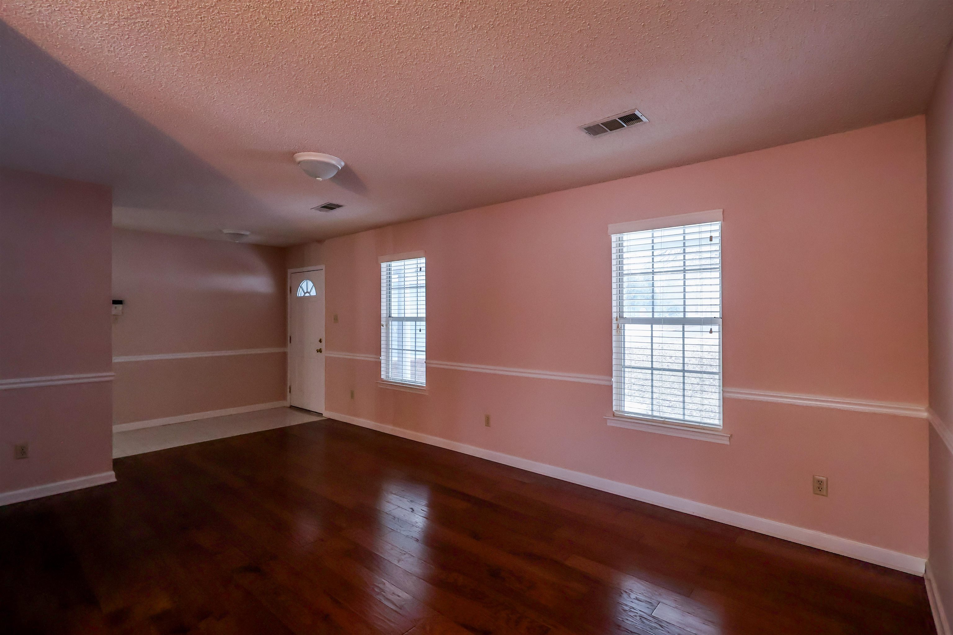 8712 Gragg Road Millington, TN 38053 - Photo 9 of 36 Spare room featuring dark wood finished floors, healthy amount of natural light, and a textured ceiling