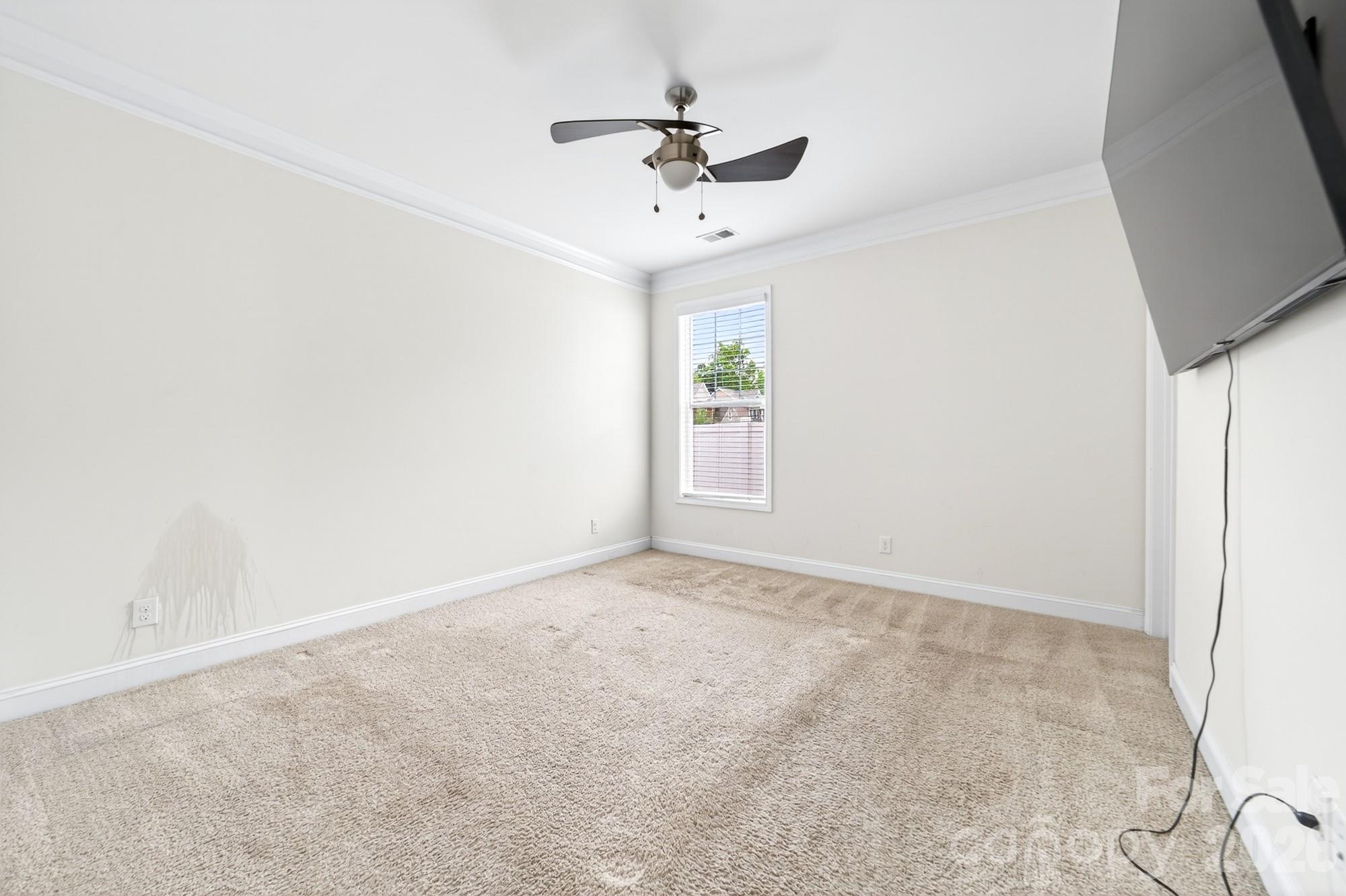 5972 Redwood Pine Road Concord, NC 28027 - Photo 17 of 37 an empty room with a ceiling fan and window