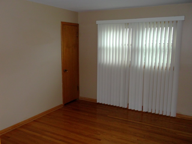 10854 Major Avenue Chicago Ridge, IL 60415 - Photo 12 of 24 an empty room with wooden floor and windows