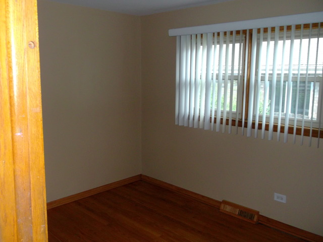 10854 Major Avenue Chicago Ridge, IL 60415 - Photo 14 of 24 a view of an empty room with wooden floor and a window