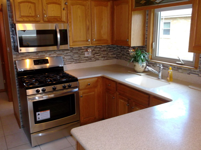 10854 Major Avenue Chicago Ridge, IL 60415 - Photo 5 of 24 a kitchen with granite countertop a sink stove and microwave