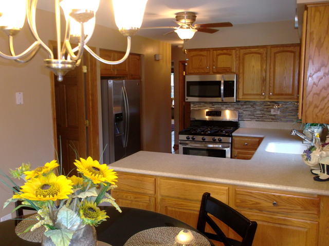 10854 Major Avenue Chicago Ridge, IL 60415 - Photo 10 of 24 a living room with furniture a fireplace and a chandelier