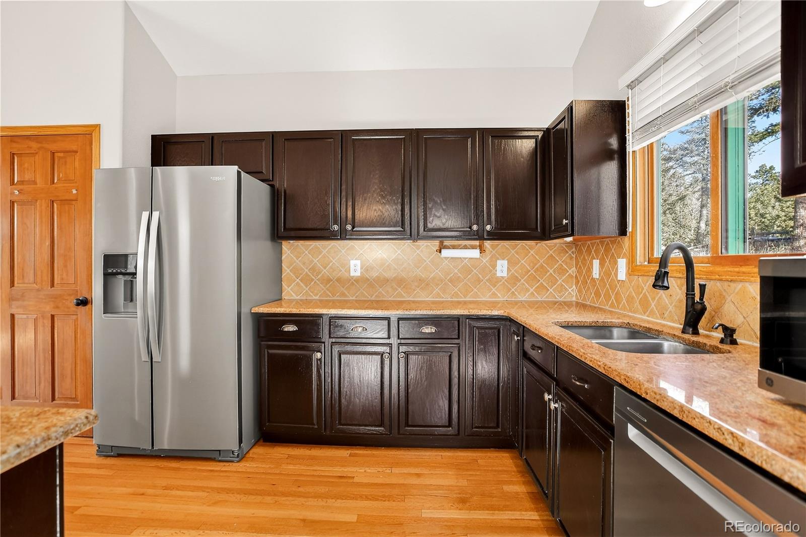9758 Fallen Rock Road Conifer, CO 80433 - Photo 11 of 42 a kitchen with stainless steel appliances granite countertop a refrigerator and a sink