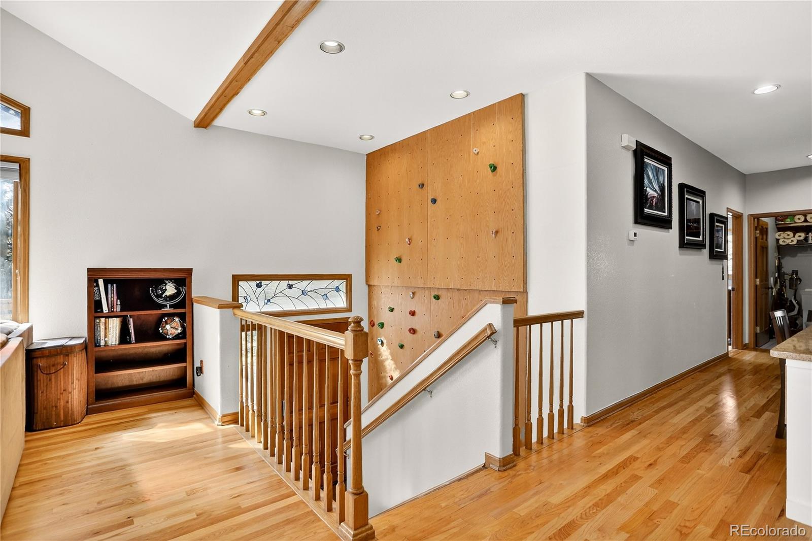 9758 Fallen Rock Road Conifer, CO 80433 - Photo 12 of 42 a view of a hallway with the wooden floor and staircase
