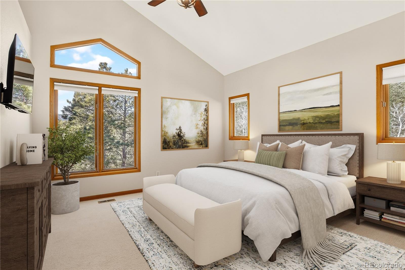 9758 Fallen Rock Road Conifer, CO 80433 - Photo 13 of 42 a spacious bedroom with a bed and a large window