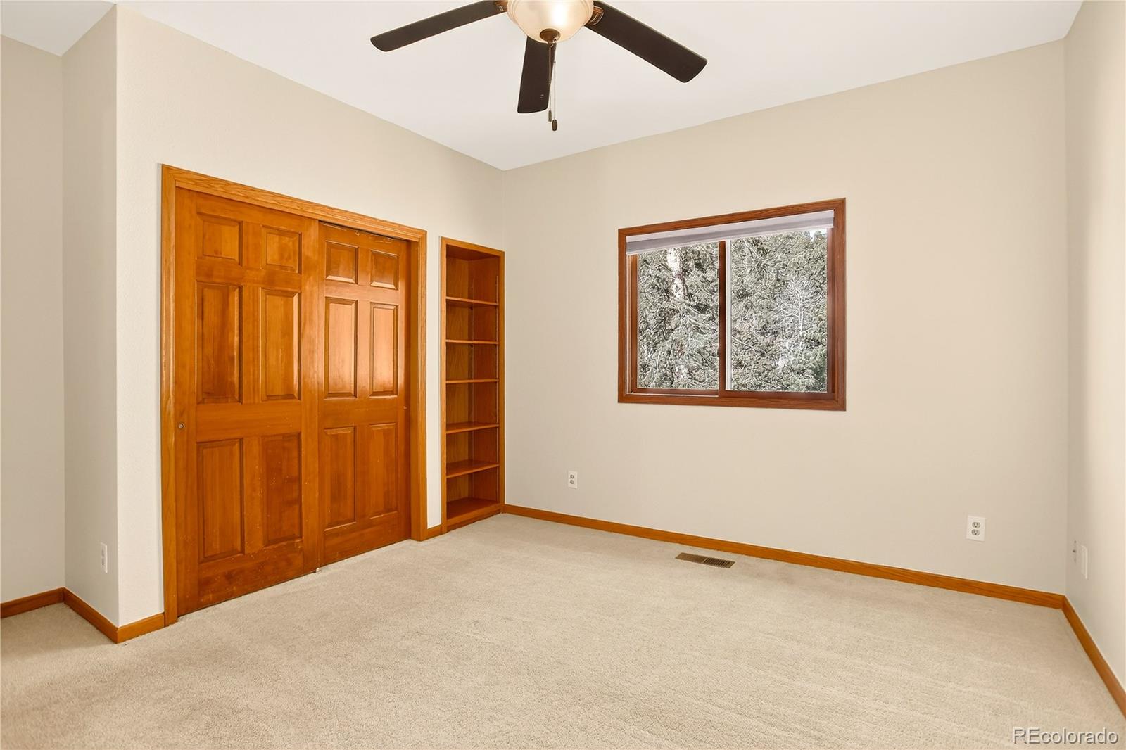 9758 Fallen Rock Road Conifer, CO 80433 - Photo 18 of 42 a view of an empty room with a window
