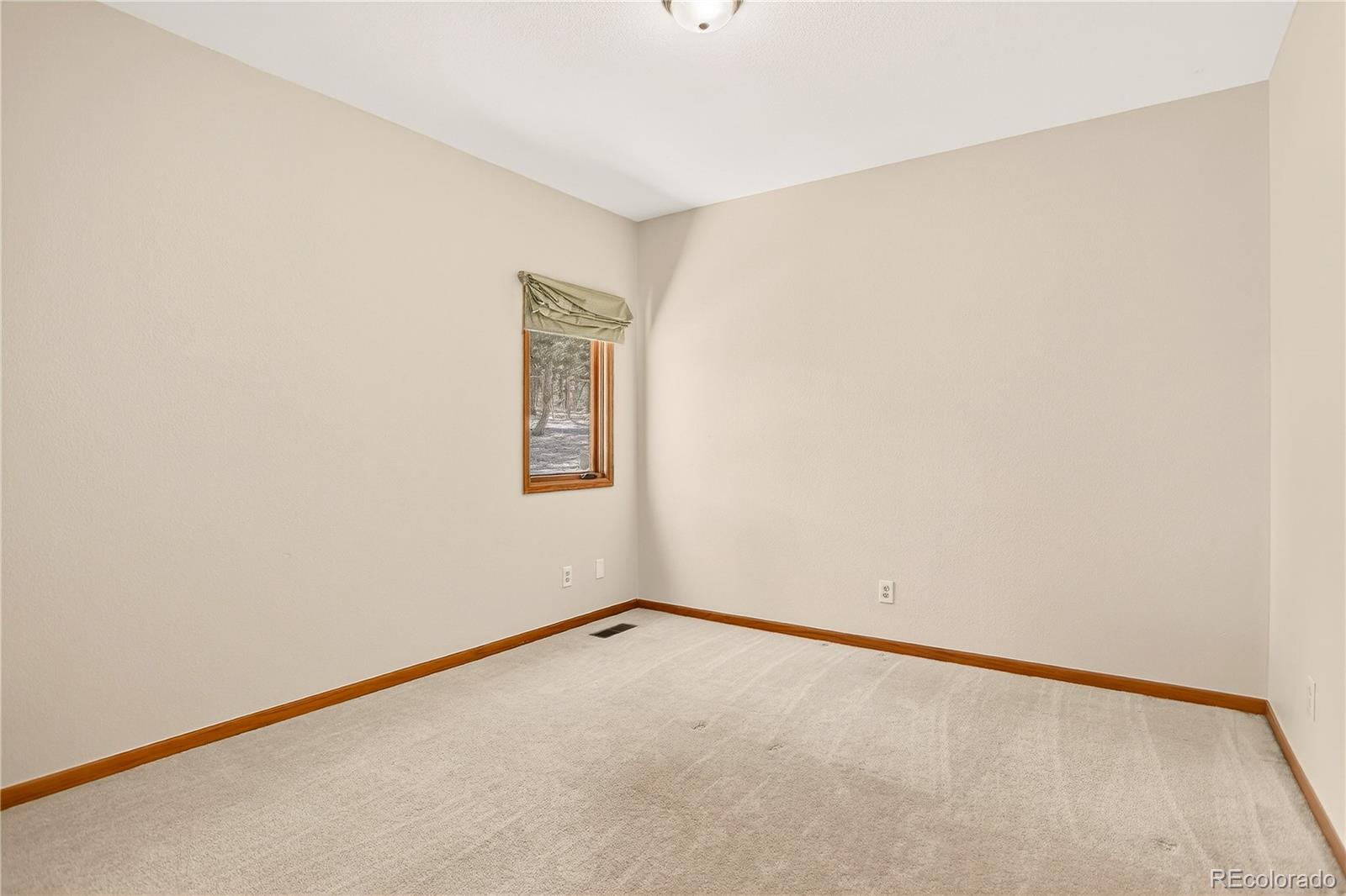 9758 Fallen Rock Road Conifer, CO 80433 - Photo 19 of 42 a view of an empty room