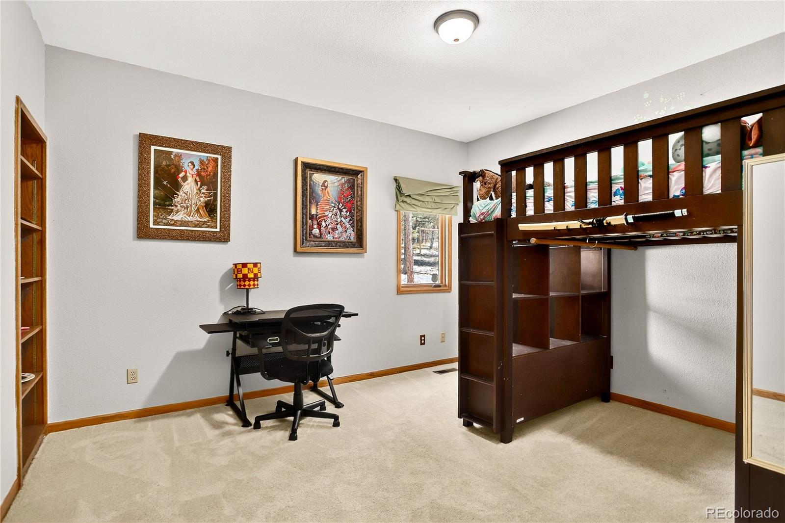 9758 Fallen Rock Road Conifer, CO 80433 - Photo 20 of 42 a living room with furniture and a window