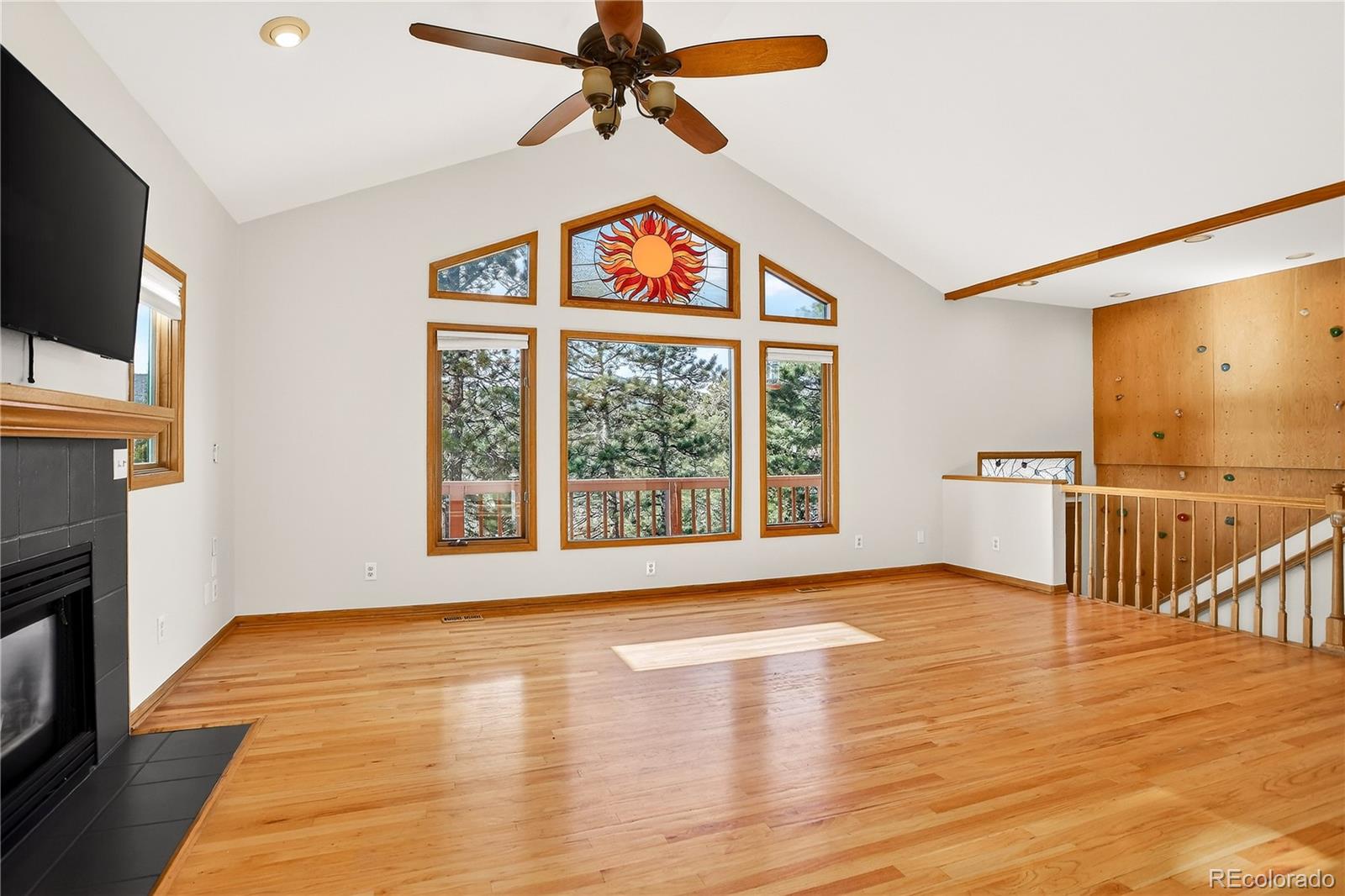 9758 Fallen Rock Road Conifer, CO 80433 - Photo 2 of 42 a view of an empty room with a window and wooden floor