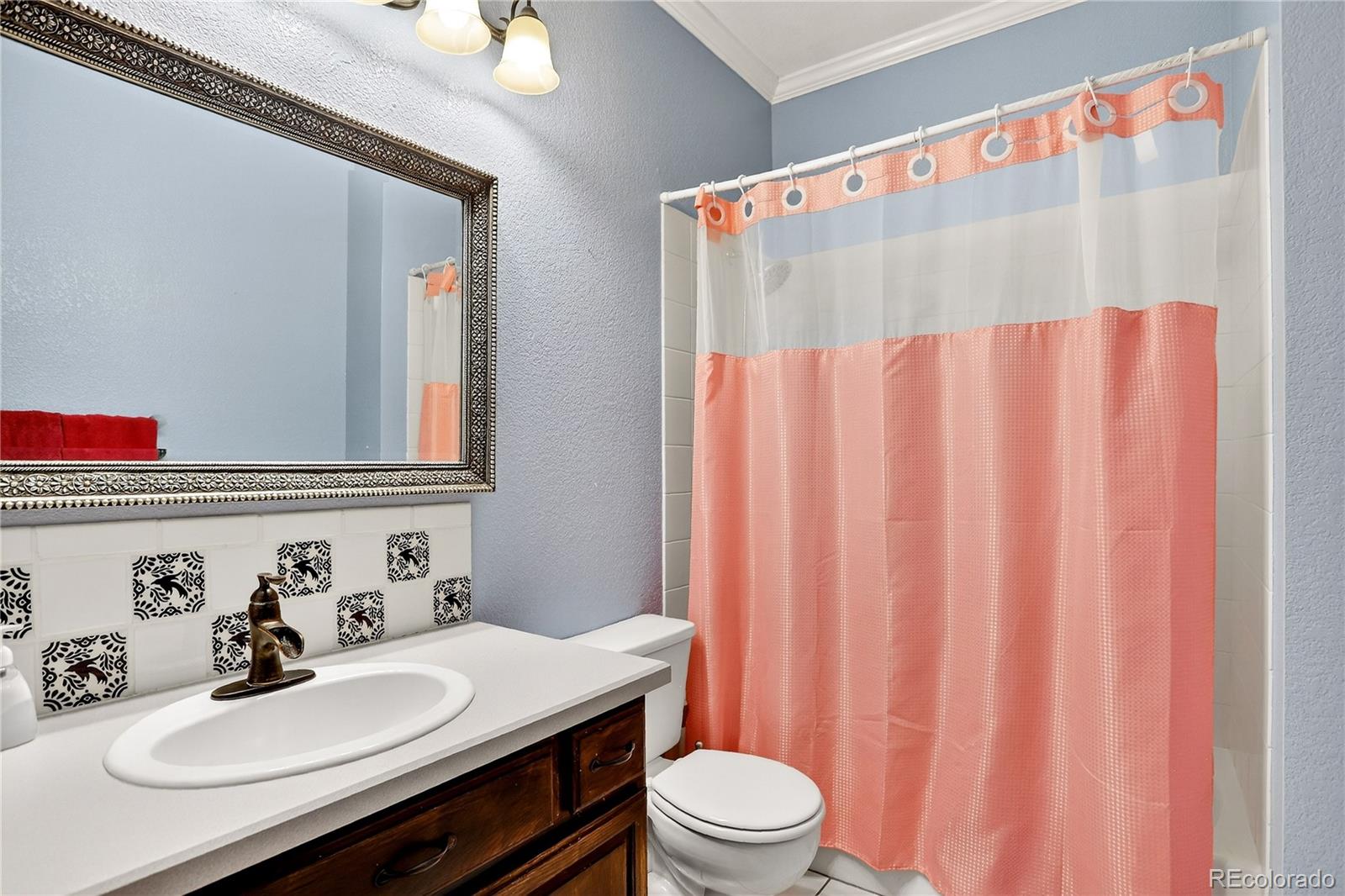 9758 Fallen Rock Road Conifer, CO 80433 - Photo 21 of 42 a bathroom with a sink vanity mirror and toilet