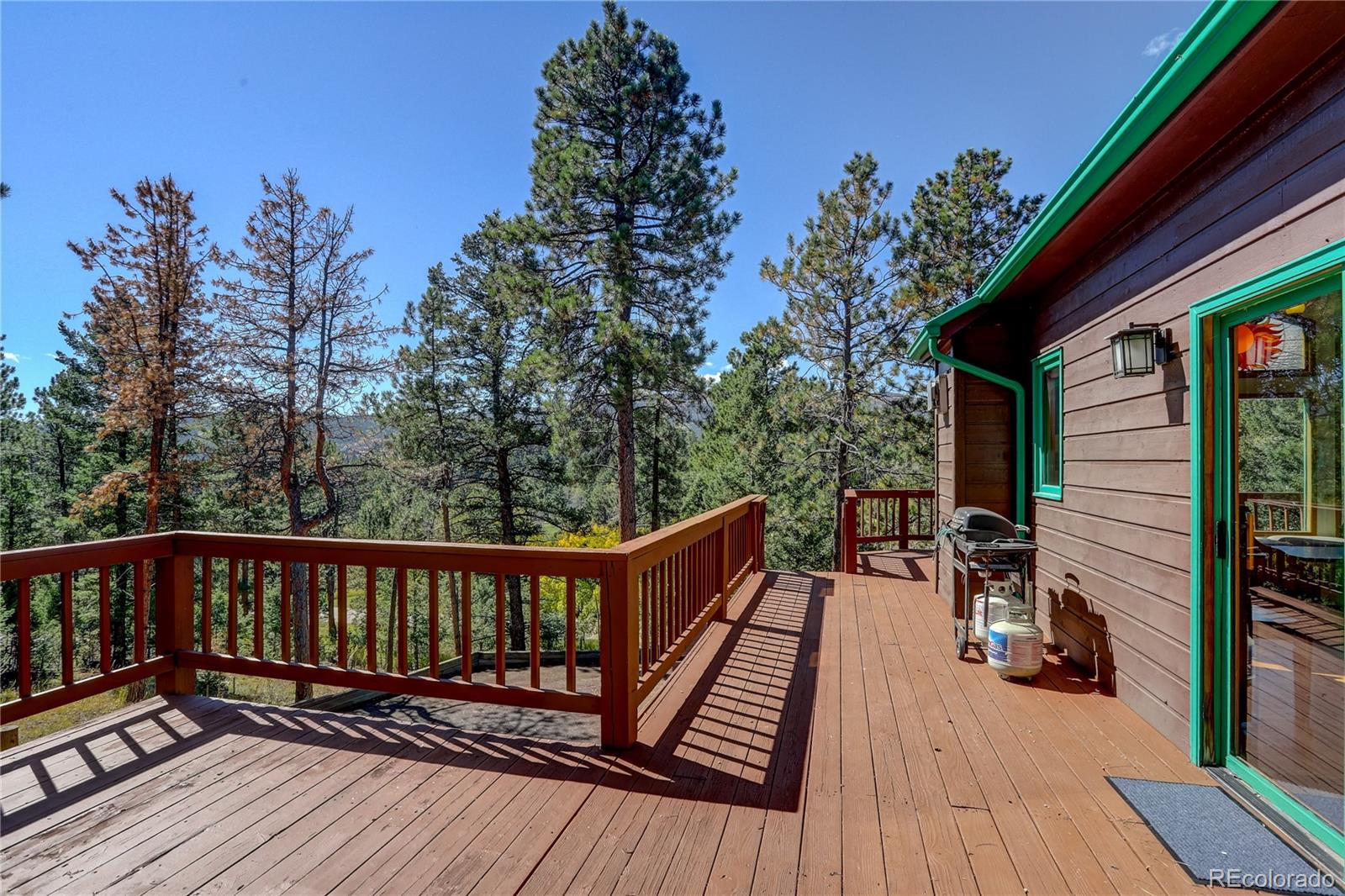 9758 Fallen Rock Road Conifer, CO 80433 - Photo 27 of 42 a view of wooden deck and a backyard