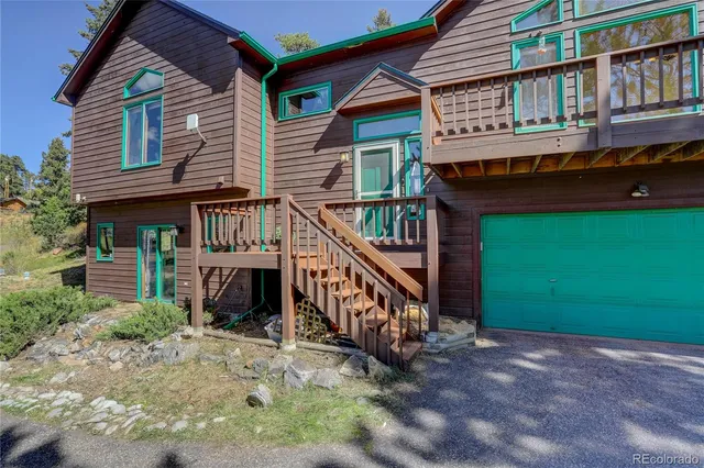 a view of a house with a yard and deck